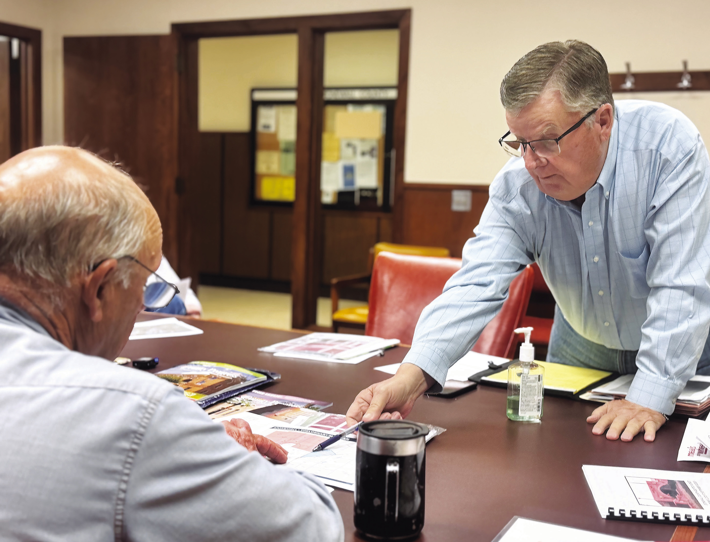 Landowner Brian Snodgrass identifies an alternative location for the proposed Crusoe data center for Commissioner Gary Myers during the May 26 meeting.. PHOTO BY JEFF HURT