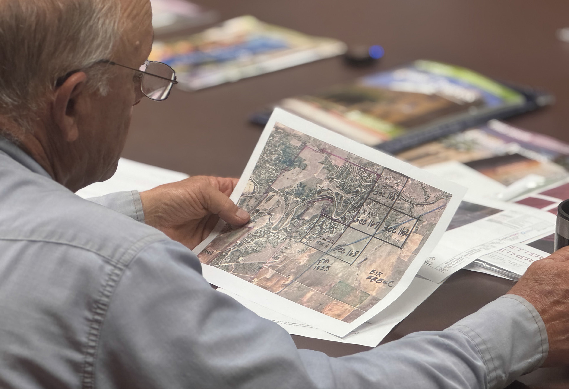 Stonewall County Commissioner Gary Myers reviews the site location of the proposed Crusoe Data Center during a May meeting.