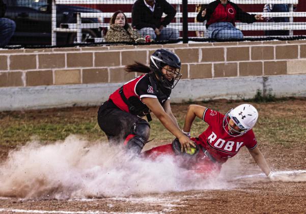 Left: Roby's Ariela Castaneda slides into home plate to beat the tag from Aspermont catcher Peyton Calamaco during the Lady Lion's 20-13 win over the Lady Hornets Tuesday night. With the win, the Lady Lions improve to 2-2 in District play. PHOTO BY MARK MARTINEZ