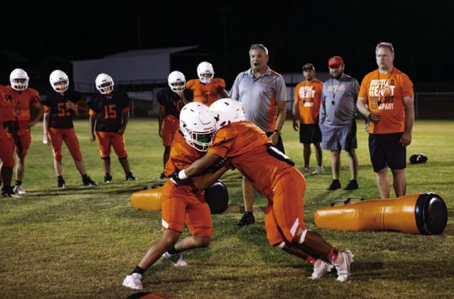 Rotan Head Coach Troy Sparks leads his team through tackling drills at Rotan's Midnight Madness Practice. Photo by Mark Martinez.