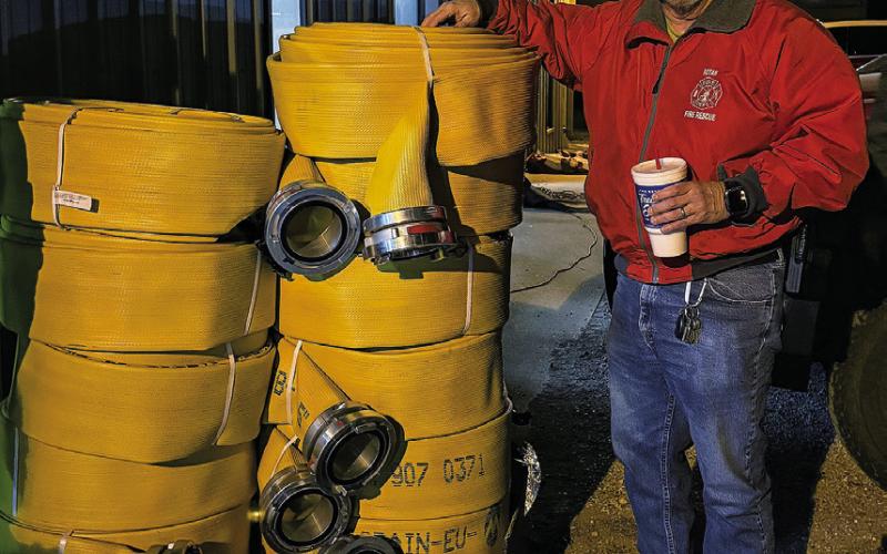 Fisher County Fire Marshall Robert Hoffman stands beside new fire hose purchased with help from a $10,000 IREN grant. The grant allowed the Rotan Volunteer Fire Department to equip Truck 87 with 1,100 feet of new hose. PHOTO BY CHEYANE HUSTON