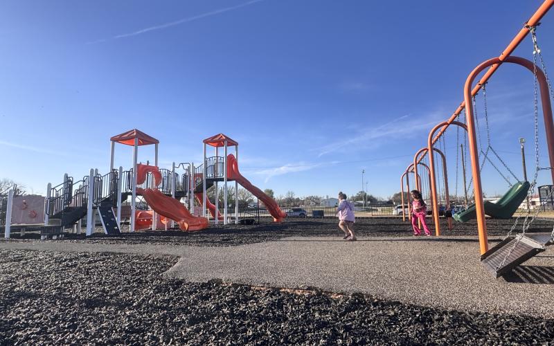 Children play on the newly installed rubberized mulch at the Rotan city park this week. The upgraded surface replaces older wood chips and is expected to provide a more durable play area.