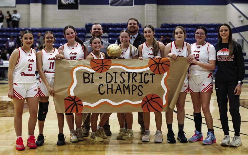 The Rotan Lady Hammers and their coaching staff with the Bi-District title after defeating Munday 38-32. Photo by: Mark Martinez