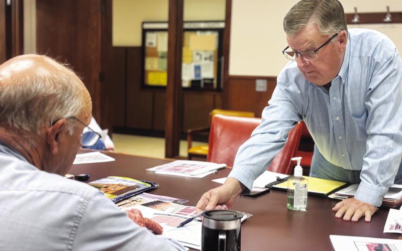 Landowner Brian Snodgrass identifies an alternative location for the proposed Crusoe data center for Commissioner Gary Myers during the May 26 meeting.. PHOTO BY JEFF HURT
