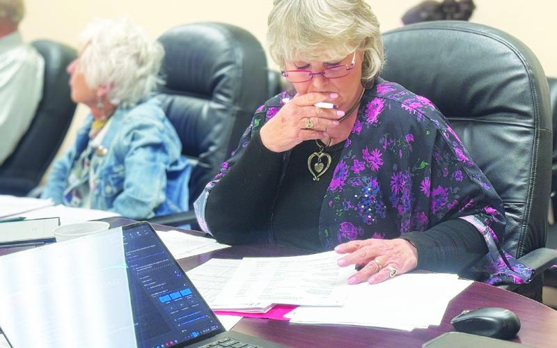 SMHD Board President Ellen Abernathy reviews information regarding the tax abatement application regarding the proposed data center from Crusoe, a major AI developer operating in the region. PHOTO BY JEFF HURT