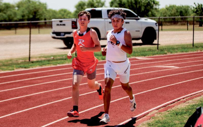 Rotan’s Chris Newton (left) running the 3200.