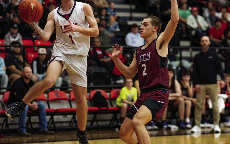 Roby senior Dallas Shumaker looks for an open man before jumping out of bounds. Photo by: Mark Martinez