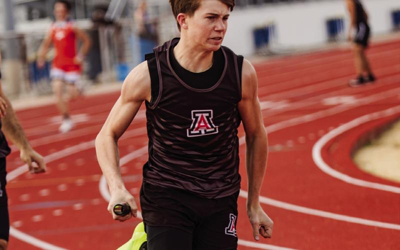 Aspermont's Graden Rabel takes the hand off in the 4x200M Relay. Photo by: Mark Martinez