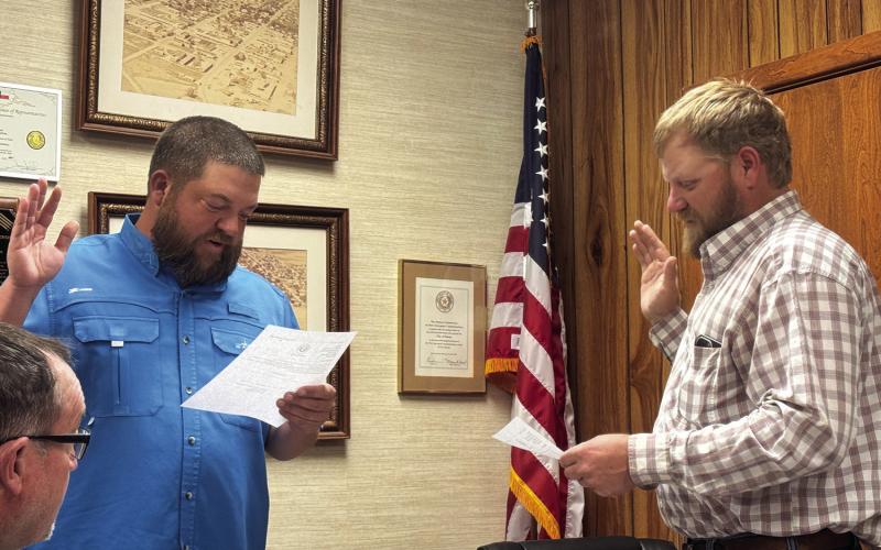 Mayor Zack Johnson administers the oath of office to James Tanner Park during a recent Rotan City Council meeting, swearing Park in to fill the vacant council seat left by Joy Dennis, who resigned while campaigning for Fisher