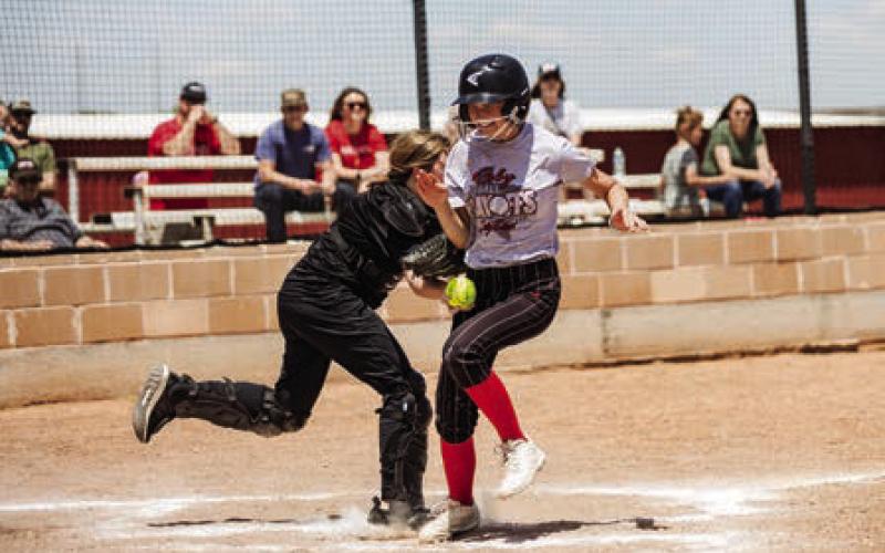 Top: Lady Lion Alumni player Allison Porter sending a pitch. Bottom: Lady Lion Alumni player Taylor Moore tags out freshman player Staleigh Young at home plate. Photos by: Mark Martinez