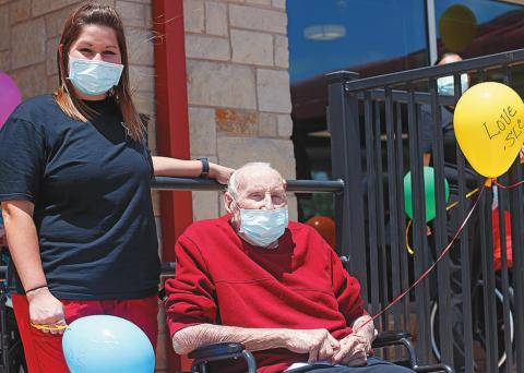 Megan Blocker LVN and Stonewall Living Center resident Bobbie Boyles prepare to release balloons for the final day of celebration during Nursing Home Week.