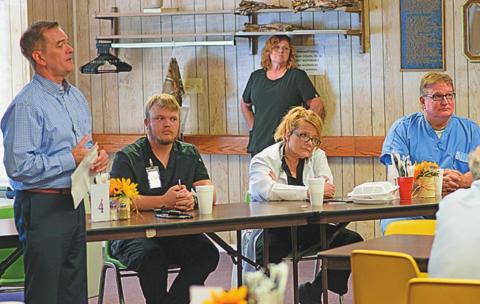 Stonewall Memorial Hospital District CEO Kyle Lee and Dr. Frederic Passmann introduce newly hired medical staff, Dr. Gwen Gorman and NP Kobie Benham while sharing lunch with community members last week at the Stonewall Senior Citizens Center.