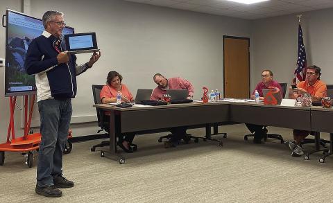 Rotan ISD Technology Director Randy Hodges gives trustees some hands-on instruction for the new computers the district issued district trustees on Monday, allowing board members to keep in contact with school officials even in remote locations.