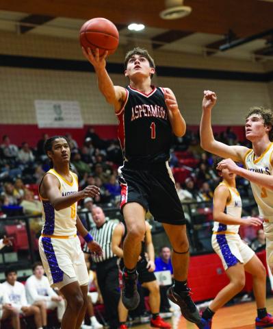 Aspermont junior Caleb Broshears cuts through the Munday defense for a layup during the Hornets 48-77 loss to the Moguls Tuesday night in the Bi-District round. The Hornets were able to keep pace with the Moguls through the first quarter before the Munday offense began pick things up and pull further away as the match progressed. The Hornets ultimately finish the season with a (16-14) record and 3rd place in District. Photo by: Mark Martinez