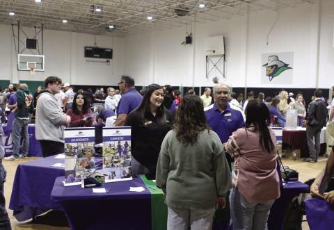 Western Texas College recruiters Isrell Lawson and Raúl Alcalá speak with prospective students at the 2024 College Fair.