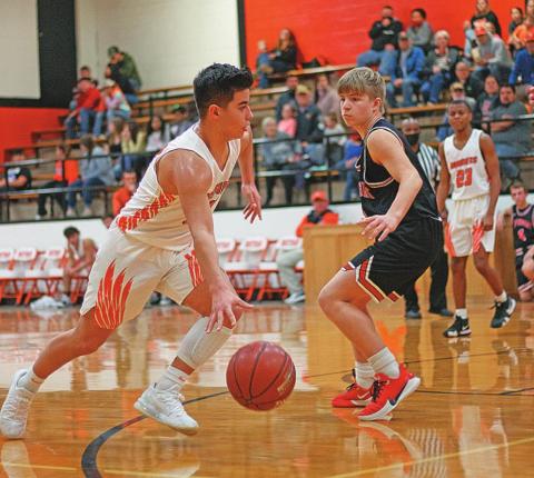 Rotan Yellowhammer Sophomore, Jaxon Warren drives around Aspermont Sophomore Keltyn Van Meter, towards the basket.