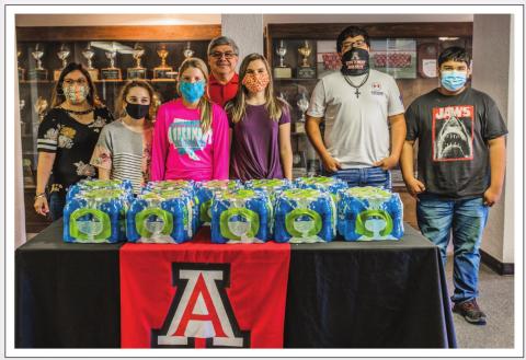 Elsie Castenada (pictured left) with a few masked Aspemont HS student volunteers and along with Principal Ronnie Garcia (back row)