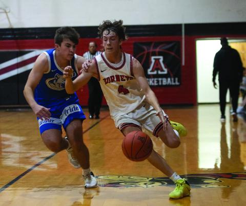 Aspermont senior Kade Morris fast breaks down the court during the Hornets 30-51 loss to Abilene Christian this past weekend at their home tournament. (Photo by Mark Martinez)