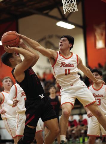 Rotan senior Juan Garza blocks a shot attempt by Roby's Dylan Lujan during the Hammers' 40-47 loss to the Lions last Friday night. Photo by Mark Martinez