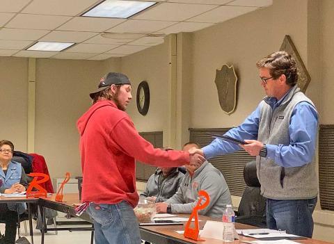 Rotan ISD Board President Britt Sipe, shakes the hand of Sam Denton who accepted his father, Rodney Denton's service award.nt Britt Sipe shakes the hand of Sam Denton who accepted his father, Rodney Denton's service award.
