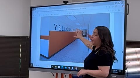 WRA Architects project coordinator Monica Castillo shows Rotan ISD trustees examples of proposed interior finishes during the Sept. 16 board meeting.