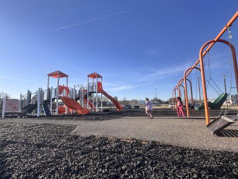 Children play on the newly installed rubberized mulch at the Rotan city park this week. The upgraded surface replaces older wood chips and is expected to provide a more durable play area.