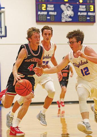 Aspermont Hornet Kade Morris, weaves through Hihgland defenders Photo by: Mark Martinez