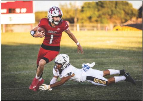 Sophomore Kullen Daniel slips a tackle from a buffaloe defender during Roby's 65-48 win over Petersburg last Friday night in Roby. The Lions found themselves in a shootout early on in the match, trading blows until the end of the first half leading 30-28. Roby would come out strong in the second half, outscoring the the Buffs 35-20 to come out on top. The Lions improve to 3-1 on the season and will take on Baird this Friday at 7:30pm in Roby. Photo by: Mark Martinez