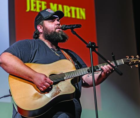 Jeff Martin from Albany bangs out the melody on guitar while delivering his rendition of Brooks and Dunn's, 'Old Man Wrigley,' taking the $500 grand prize during Stonewall Living Center's talent showcase last Friday. (PHOTO BY TRICIA HURT)