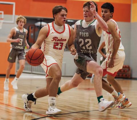 Sophomore Rhlyon Lester fast breaks to the basket pursued by a Piper defender during the Hammers 36-70 loss to Hamlin Tuesday night. PHOTO BY MARK MARTINEZ