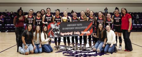 The Aspermont Lady Hornet baskeball team, coaching staff, and managers hoist the Bi-District title after a commanding 66-29 win over Harrold. Photo by: Mark Martinez