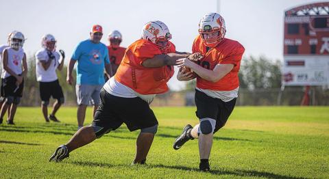 Rotan freshman Jayden Louis tags senior Michael Moffett during a drill.