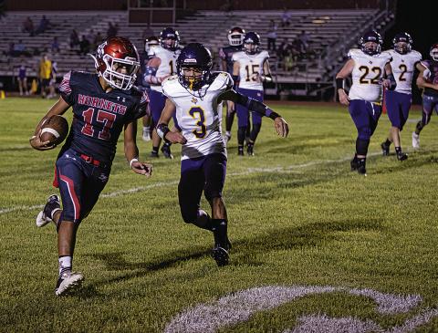 Aspermont senior Calob Castaneda slips by Bulldog defenders to score during last Friday's 56-8 win over Moran. Photo by: Mark Martinez