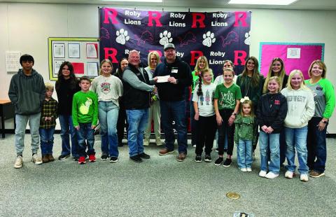 Roby CISD Superintendent Kenny Border joins students and staff to accept the $2,500 donation from Clearway Energy/Mesquite Star LLC as part of the company's Adopt a School