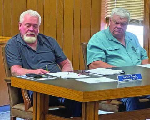 Precinct 1 Commissioner Gordon Pippin presents a request for emergency funds for purchasing road material to repair roads damaged by recent storms.