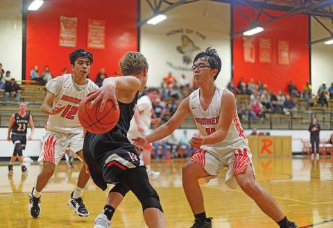 Rotan's Johnny Lujan (left) &amp; Cody Means ( right) work to contain the Raider offense. Photo by: Mark Martinez