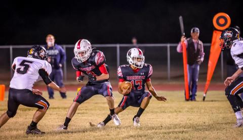 Aspermont Hornet, Caleb Castaneda prepares to make a cut to avoid Bulldog defenders
