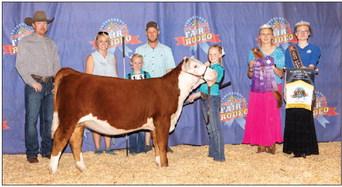 Maci Hjelmervik with her Hereford Heifer Reserve Grand Champion at the West Texas Fair and Rodeo Jr Show. Maci is the daughter of Jonathan and Nicole Hjelmervik. Her little sister Kynadi (pictured standing between her parents) also won numerous awards at this year's show.