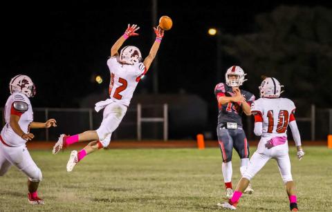 Junior, Gunner Helm, tips a pass from Hornet Quarterback Josiah Coplen