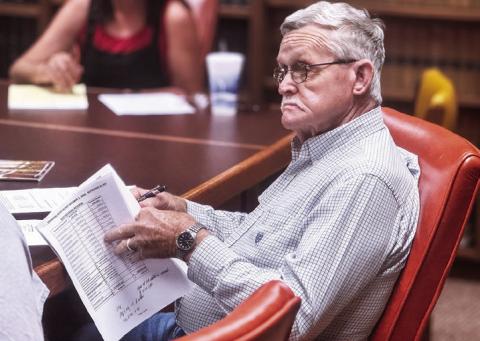 Stonewall Commissioner Gerry Messick reviews the county’s budget as the county discusses subtle changes from last year’s budget to the proposed FY 2026 budget cycle as primary tax revenue shifts from minerals to real property values. PHOTO BY JEFF HURT