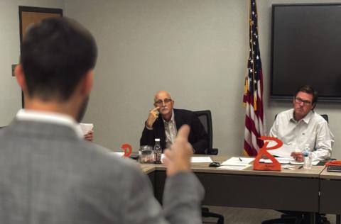 Rotan ISD interim superintendent Dr. Burks board president Britt Sipe follow along as financial advisor Jake Lawrence the presents results of the school district’s bond sale.