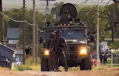 Heavily armed SWAT personnel and an armored vehicle move into position during a standoff in Rotan on Monday, August 11. Tactical units assisted local law enforcement in the safe apprehension of a barricaded suspect on East 7th Street.
