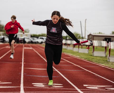 Aspermont's Macy Morris crosses the finish line during the 4x100 M Relay Photo by: Mark Martinez
