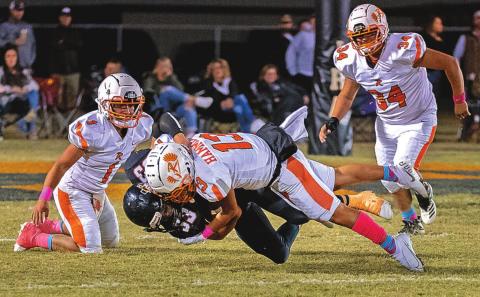 Junior, Jackson Warren takes out Number 33 Ira Bulldog during last Friday's game.