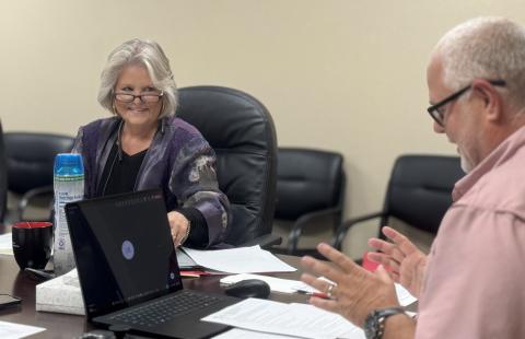 SMHD Board President Ellen Abernathy smiles with approval as CEO Michael Moorhead explains the final version of the district’s tuition reimbursement program, one Abernathy said she is excited for the hospital to put into action.