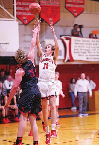 Aspermont's Olen Johnson shoots high over Roby's Eric Ragan. Photo by: Tricia Hurt