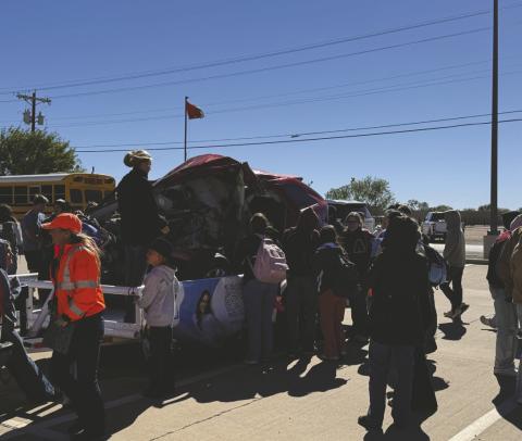Jen Blessing shares the story of her daughter, Aspen, who was killed by a drunk driver in March 2024, as Aspermont ISD students gather around Aspen’s crashed vehicle, displayed by TxDOT to raise awareness about the consequences of impaired driving.