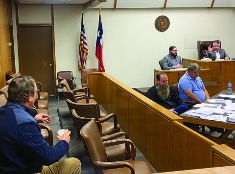 Fisher County Attorney Michael Hall and Commissioner Preston Martin debate county roads use agreements on Monday.