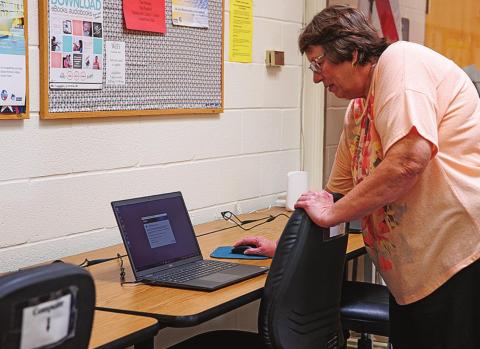 Stonewall County Librarian Kathy Boyles, shows off one of the new laptop computers that the library was able to purchase through the Texas Supports Libraries Grant during the Open House Monday morning.