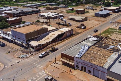 An aerial view shows the wide spread destruction to numerous downtown Rotan businesses, with significant roof damage visible to Rotan First National Bank, White's Hardware, Family Dollar and Rotan Motor. Not pictured is Angel Care which also suffered significant roof damage. (PHOTO BY DILLAN CULLIFER OF LUMINANCE STUDIOS)